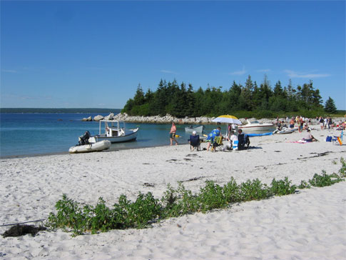 Boaters and beach goers enjoy the sunshine on Carter's beach